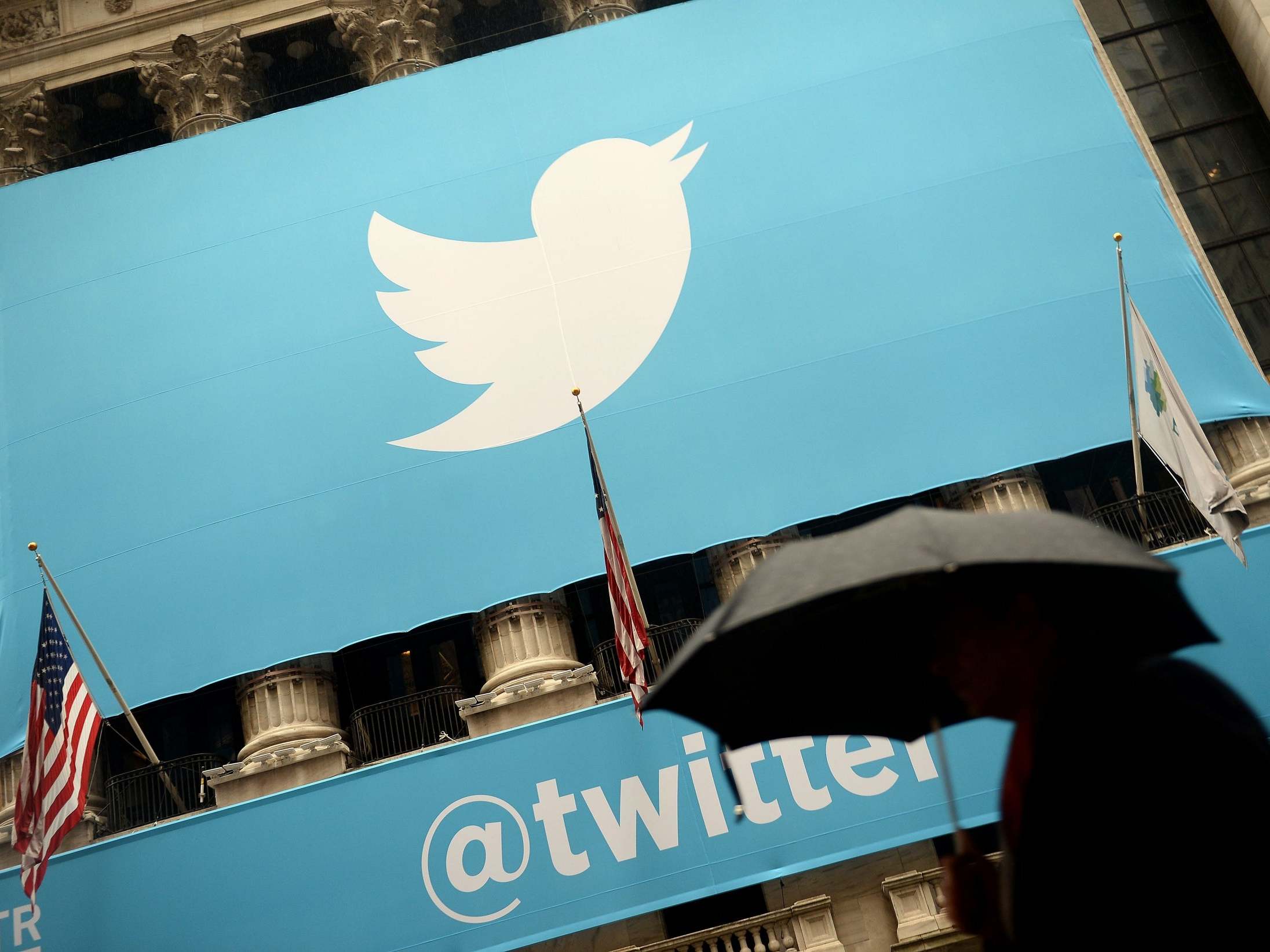 A banner with the logo of Twitter is set on the front of the New York Stock Exchange