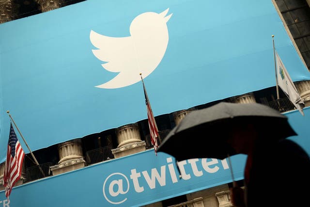 A banner with the logo of Twitter is set on the front of the New York Stock Exchange