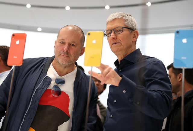 Apple CEO Tim Cook speaks to Jony Ive during an Apple special event at the Steve Jobs Theatre