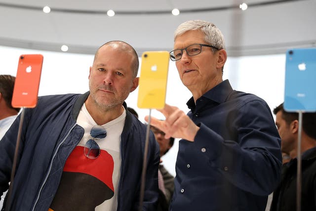 Apple CEO Tim Cook speaks to Jony Ive during an Apple special event at the Steve Jobs Theatre