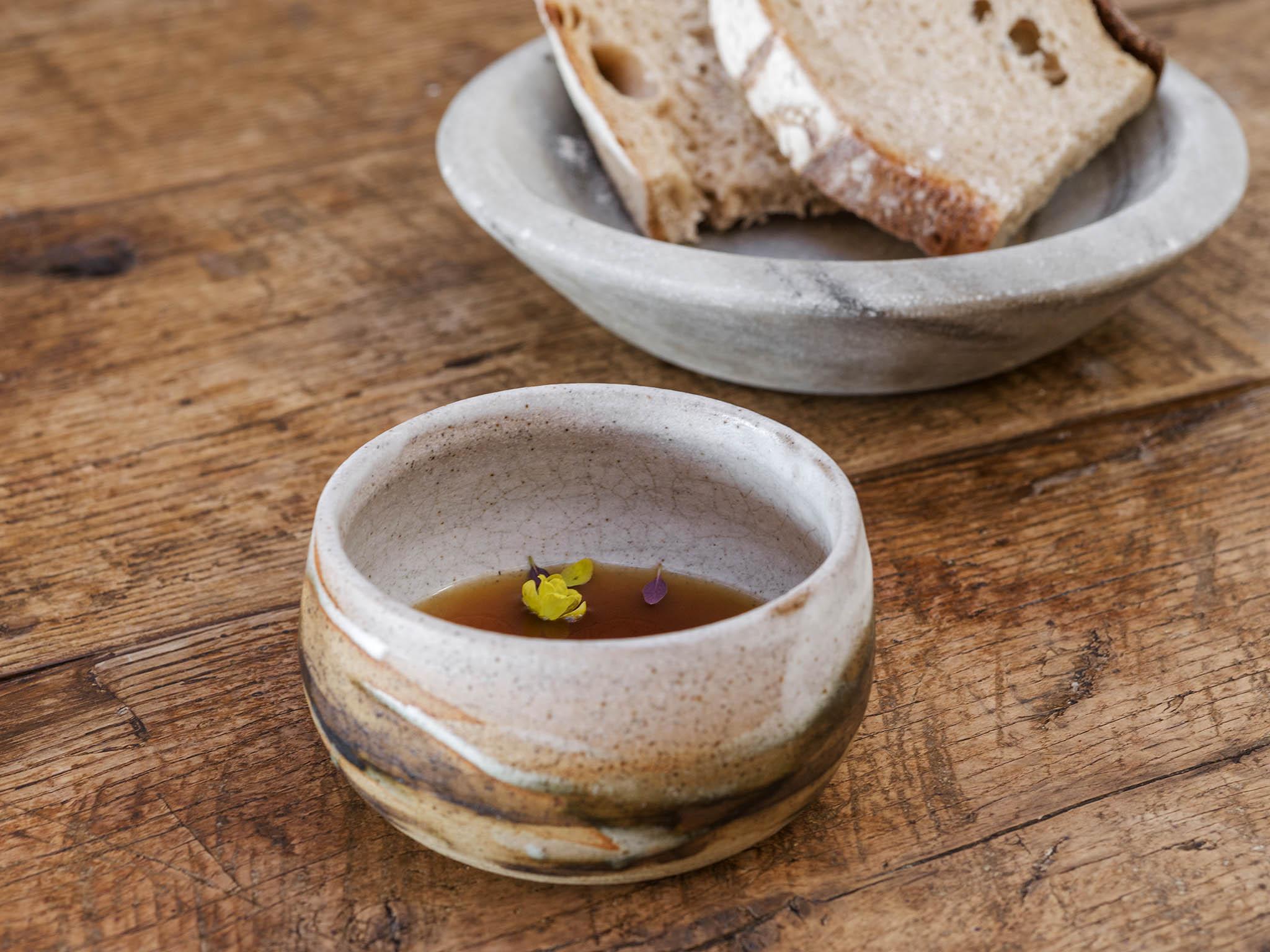 The lamb, lavender and rosemary palate cleanser palette cleanser broth and wild garlic and pepper dulse butter and bread