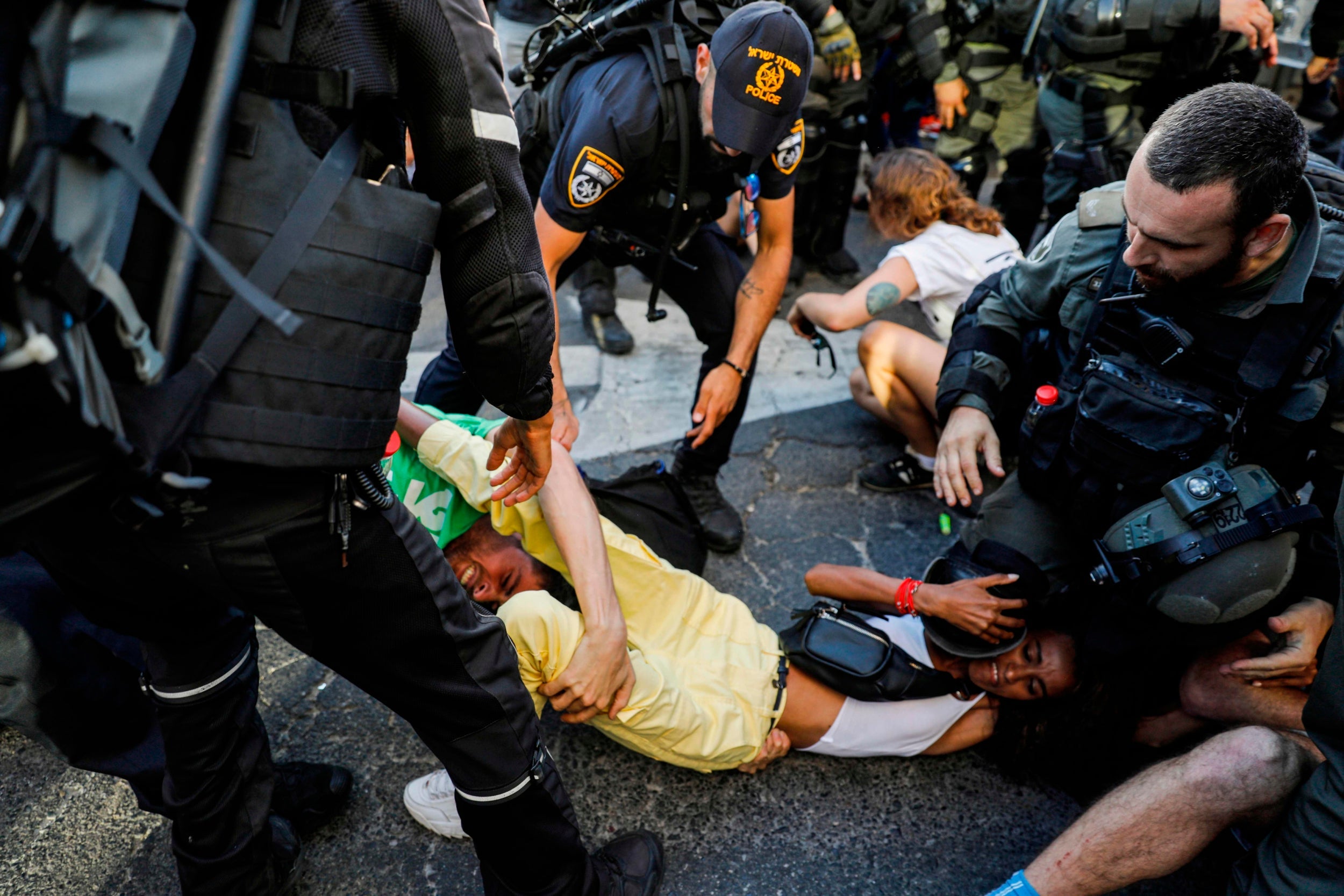 Members of the Israeli security forces detain a protester during a demonstration against killing of Solomon Teka