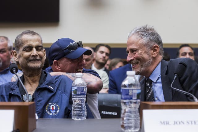 Jon Stewart (right) speaks to retired NYPD detective and 9/11 responder Luis Alvarez in Congress