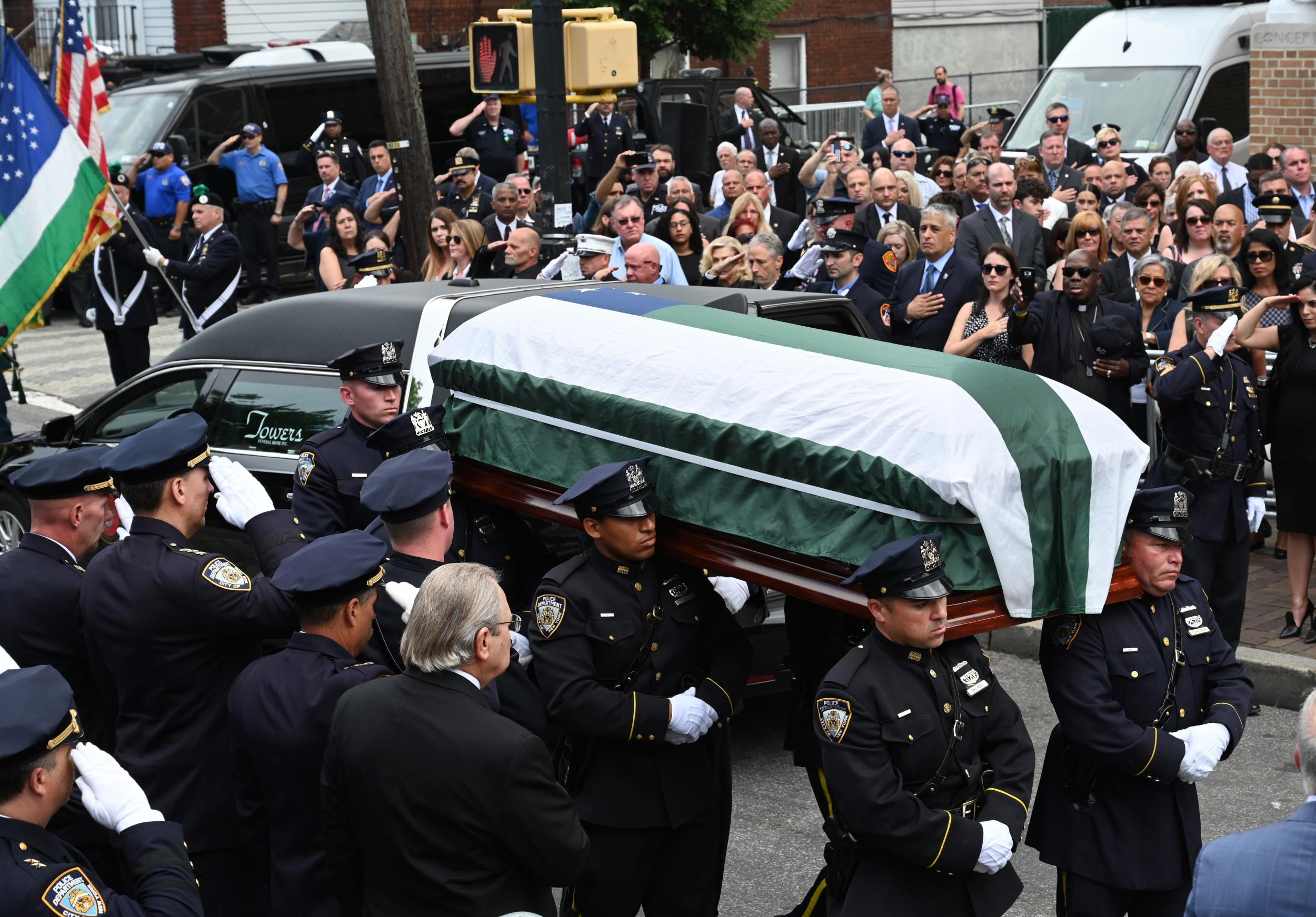 The casket of Luis Alvarez is carried outside as people attend the funeral mass at the Immaculate Conception Church