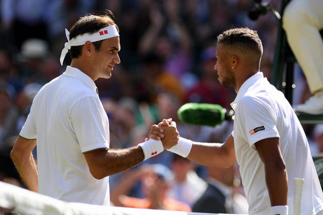 Roger Federer of Switzerland shakes hands with Jay Clarke of Great Britain