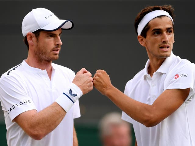Andy Murray speaks with playing partner Pierre-Hughes Herbert