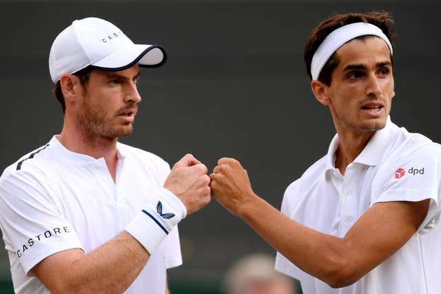 Andy Murray speaks with playing partner Pierre-Hughes Herbert