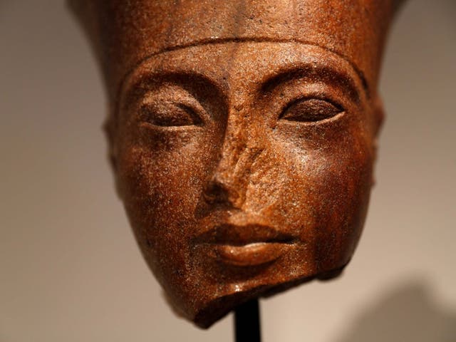 An Egyptian brown quartzite head of the God Amen is seen at Christie's auction house prior to its' sale