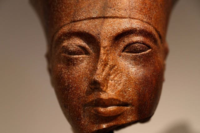 An Egyptian brown quartzite head of the God Amen is seen at Christie's auction house prior to its' sale
