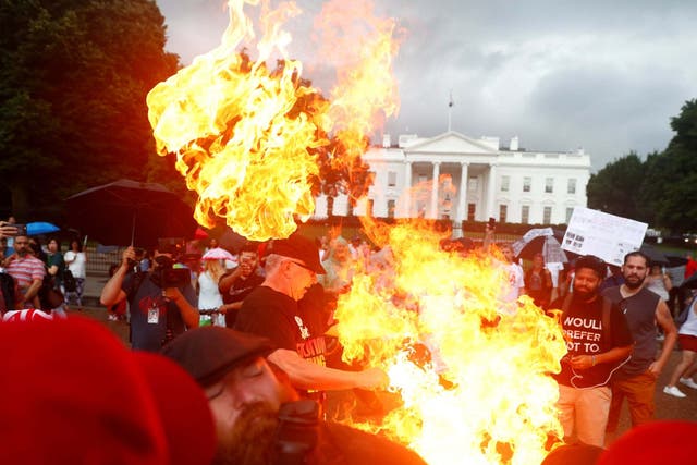 Demonstrators burn a U.S. flag in front of the White House during a Fourth of July Independence Day protest in Washington