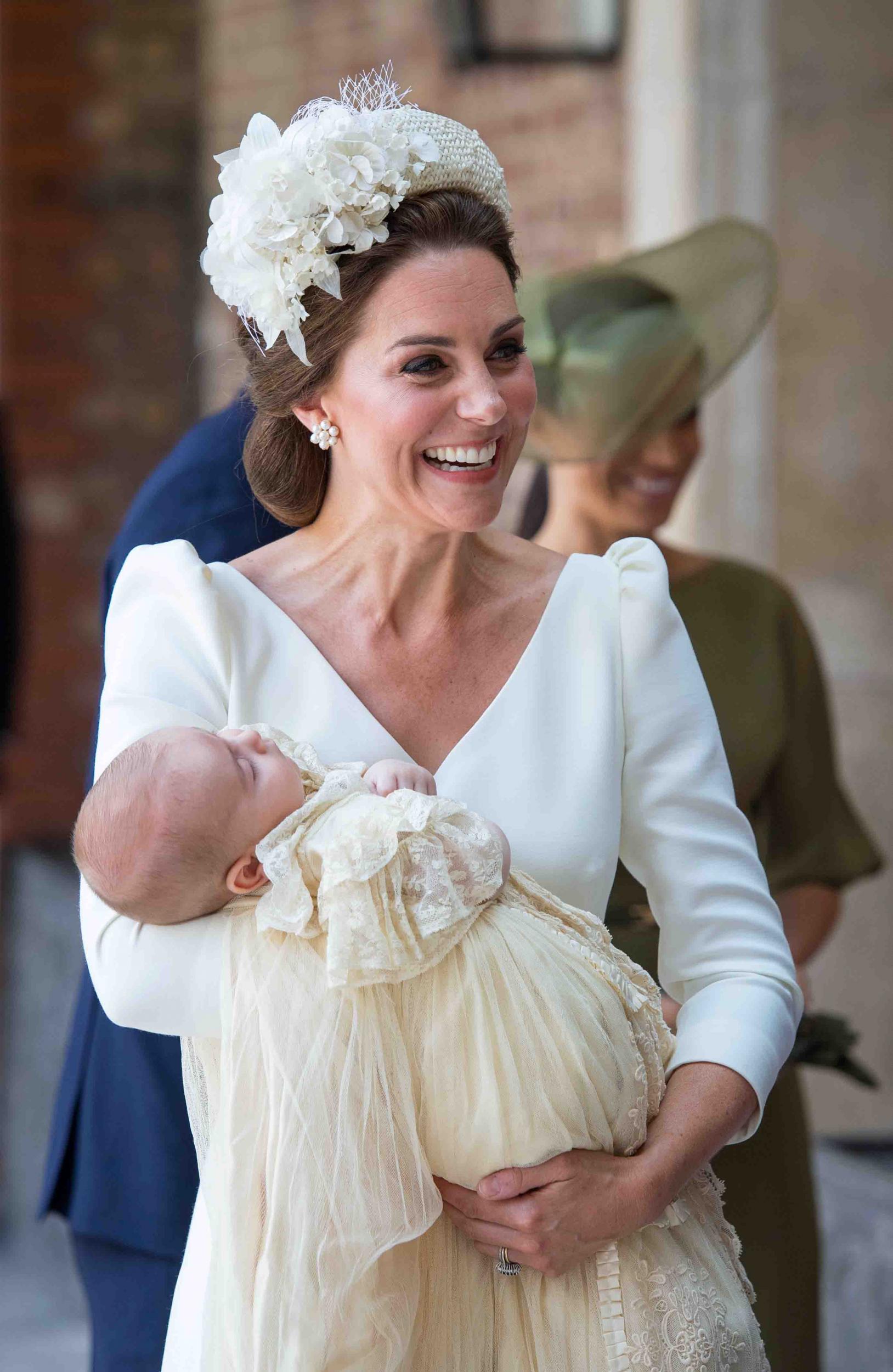 On 9 July 2018, the Duchess of Cambridge was seen arriving at the Chapel Royal, St James’s Palace, London with her family carrying Prince Louis.
For the occasion, the mother-of-three wore a simple white Alexander McQueen dress with puffed sleeves and a midi-length hem. She coordinated her outfits with a cream applique headband, known as the Cassandra, by milliner Jane Taylor. 
Prince Louis, meanwhile, was dressed in a replica of the Royal Christening Robe which was hand made by Angela Kelly, dressmaker to the Queen. 
On arriving at the chapel, Kate Middleton told the Archbishop of Canterbury that Prince Louis was 'very relaxed and peaceful', adding 'I hope he stays like this’.