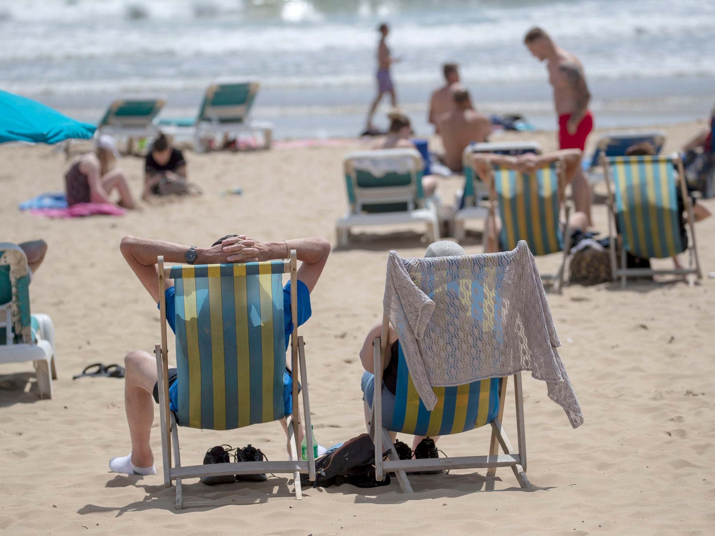 People enjoy the sunshine on the beach in Bournemouth, Dorset