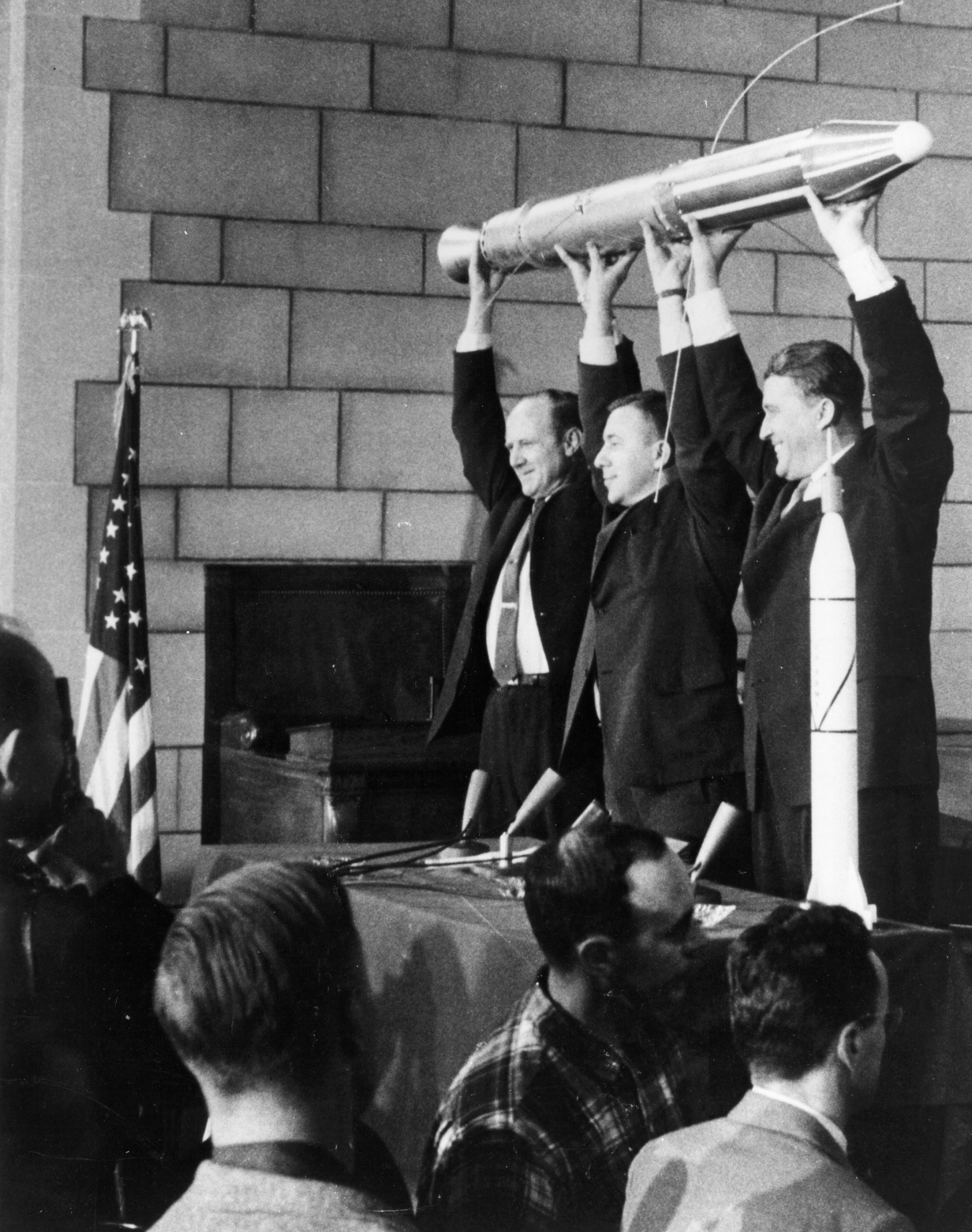Jet propulsion laboratory director William Pickering (left), Dr James Van Allen (centre), and Dr Wernher von Braun (right) hold up a model of the first US satellite Explorer 1, which successfully launched on 31 January 1958