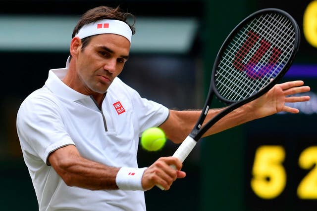 Roger Federer returns