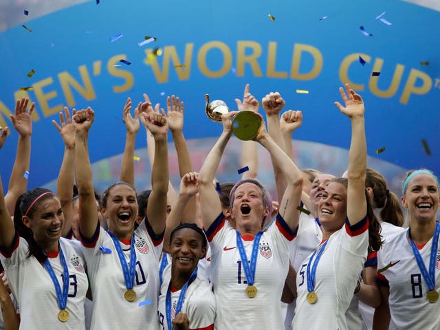 United States' Megan Rapinoe lifts up a trophy