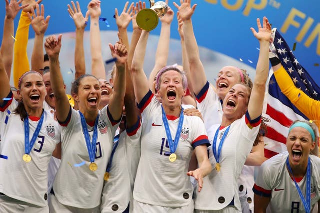 Megan Rapinoe of the USA lifts the FIFA Women's World Cup Trophy