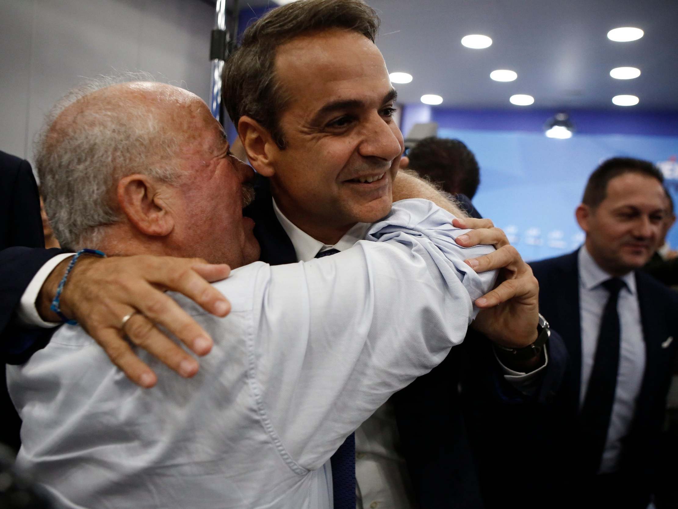 New Democracy leader Kyriakos Mitsotakis hugs supporters following election win
