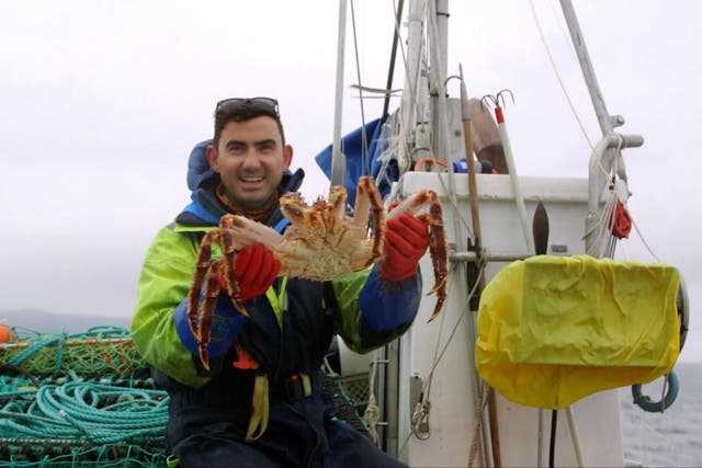 Simon Parker holding a king crab