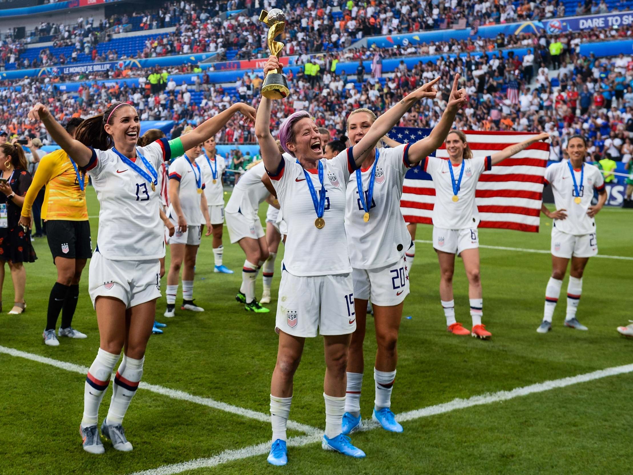 Trophy holder: Megan Rapinoe, centre, celebrates the USA's tournament victory