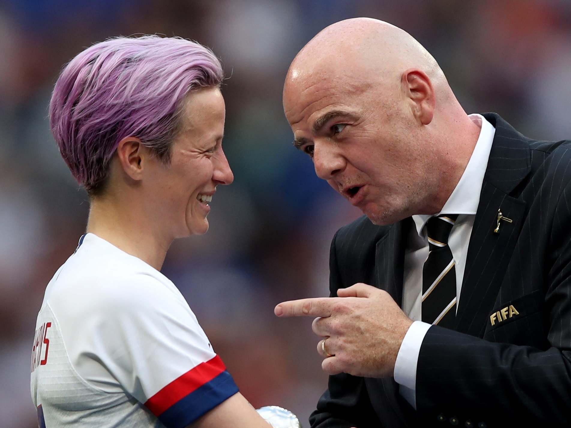 Megan Rapinoe is conducted by Fifa president Gianni Infantino
