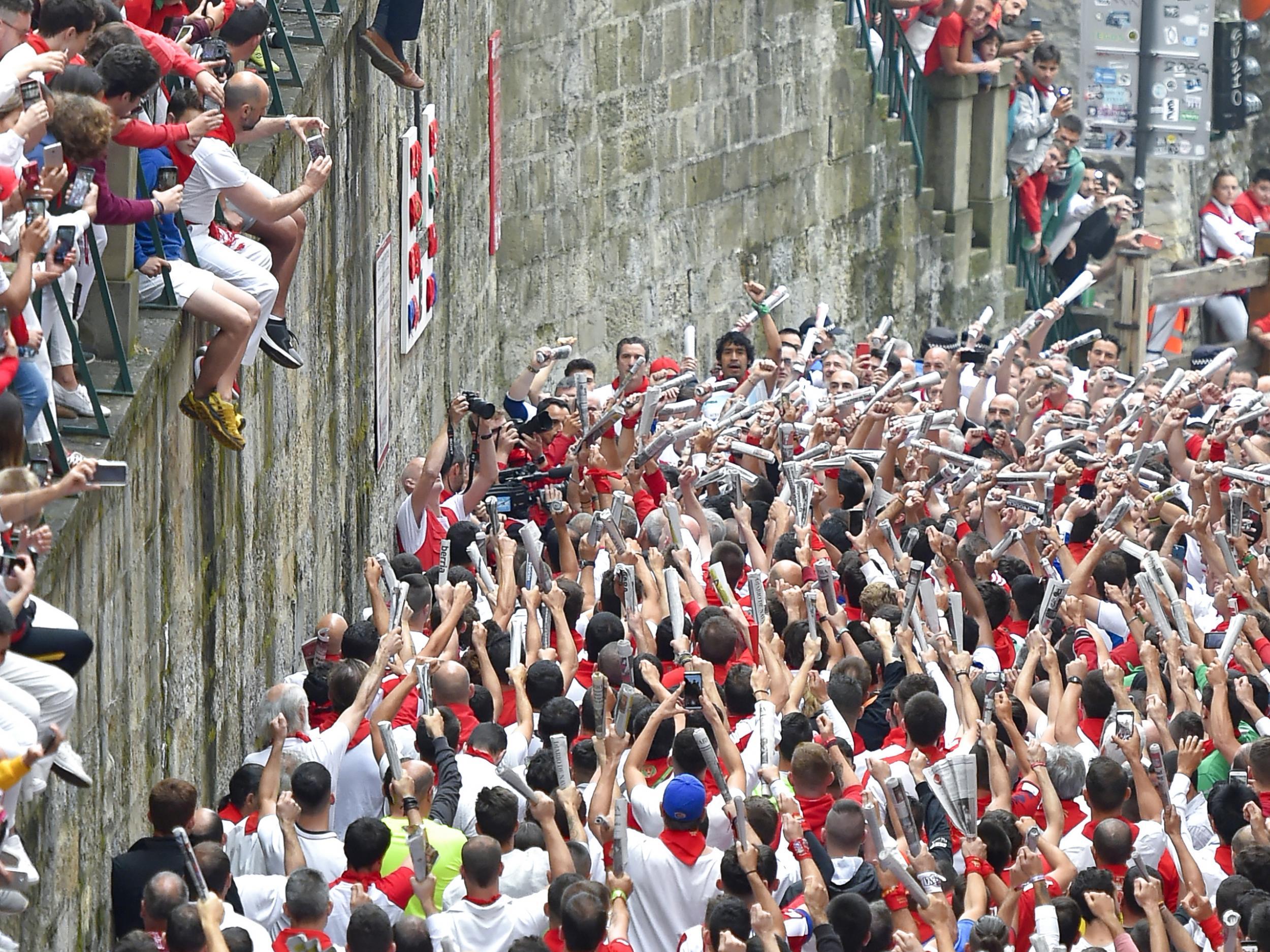 Participants singing and chanting before the day’s first bull run begins (Getty)