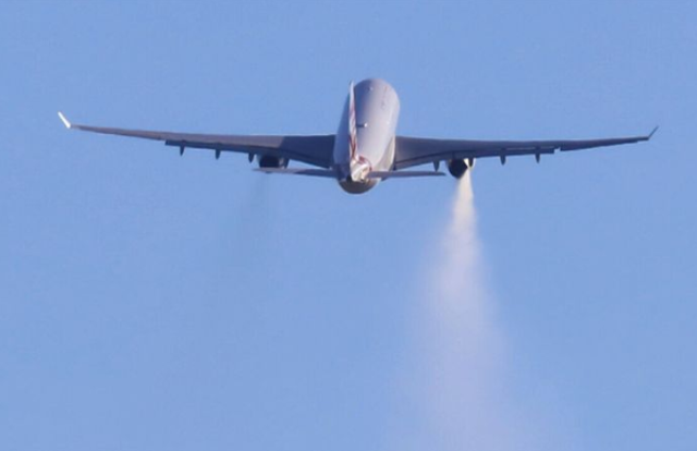 The Virgin Australia jet was seen issuing white vapour