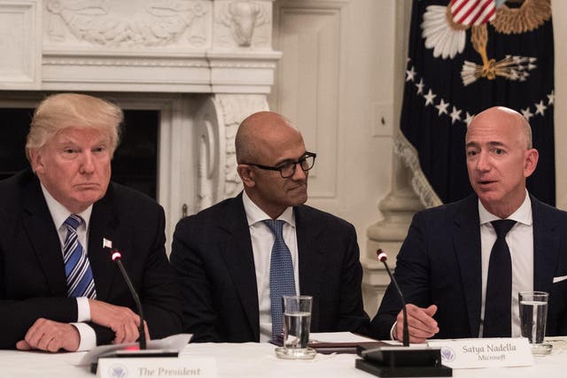 US President Donald Trump and Microsoft CEO Satya Nadella listen to Amazon CEO Jeff Bezos during an American Technology Council roundtable at the White House in Washington, DC, on 19 June 19, 2017