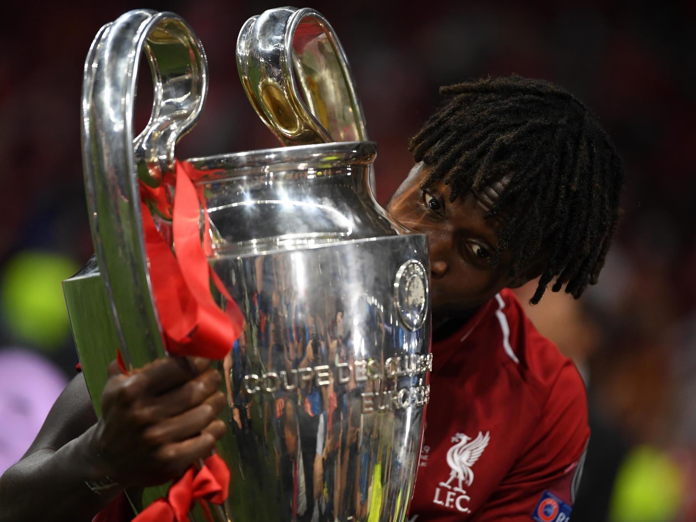 Divock Origi celebrates with the Champions League trophy