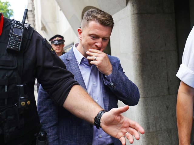Tommy Robinson leaves court after being found in contempt of court