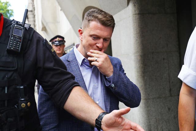 Tommy Robinson leaves court after being found in contempt of court