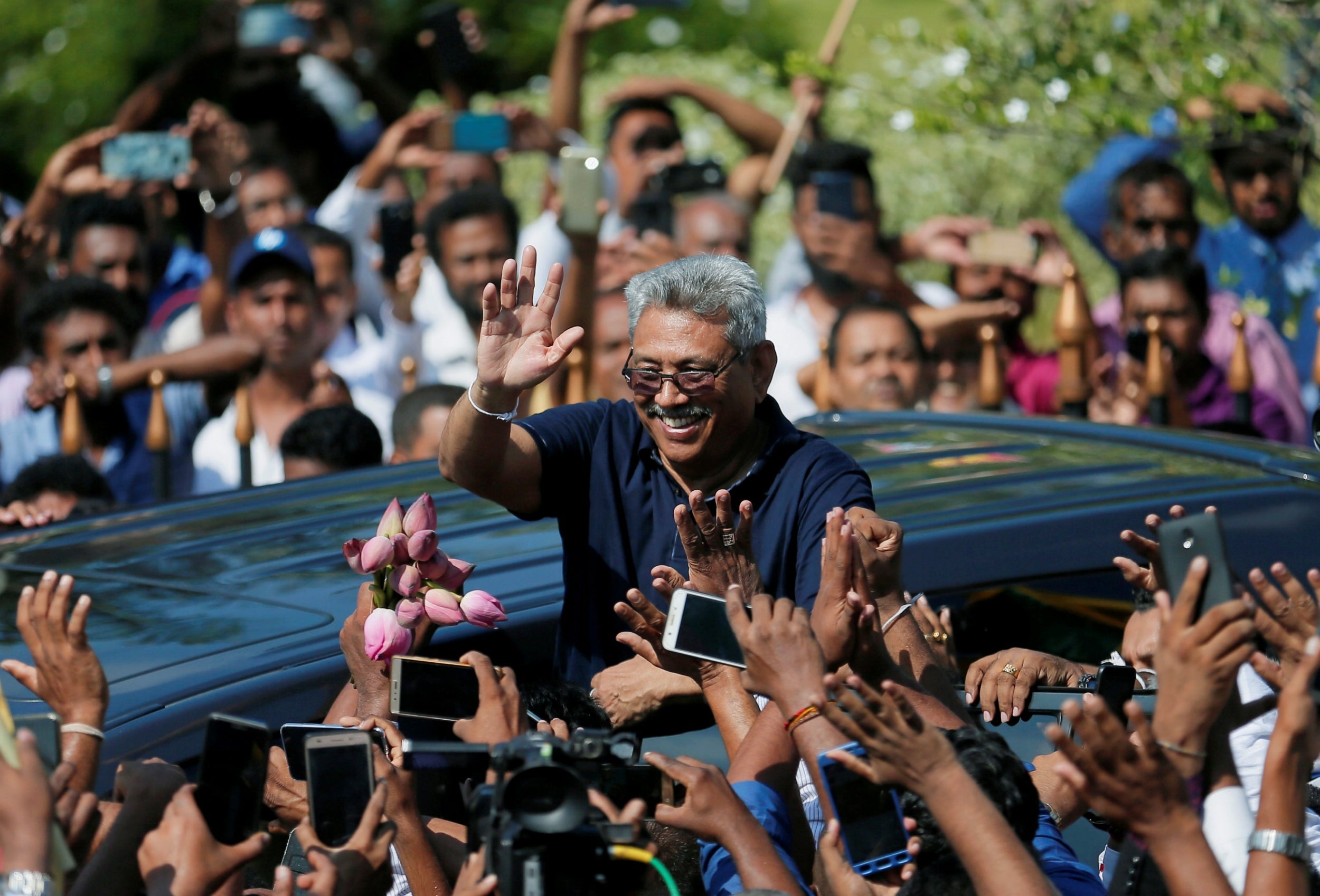 Former defence secretary Gotabaya Rajapaksa greets fans in April after returning from the US