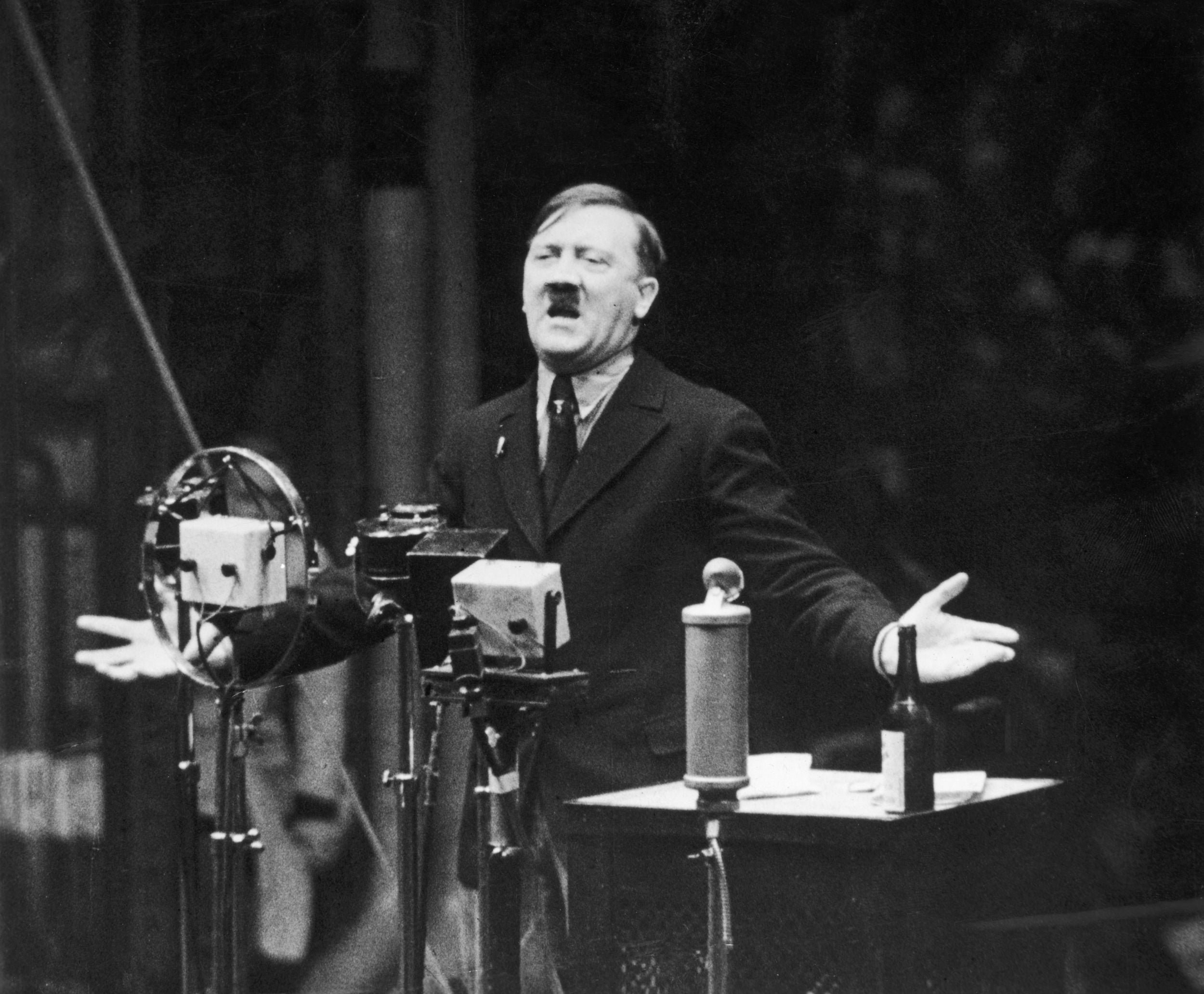 Adolf Hitler, who was obsessed with scientific discoveries, speaking in front of microphones in 1935