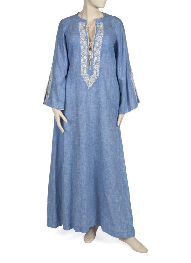 A chambray white cotton floral embroidery caftan designed by Bill Tice and worn by Elizabeth Taylor in a Terry O'Neill photo shoot with David Bowie. $1,000