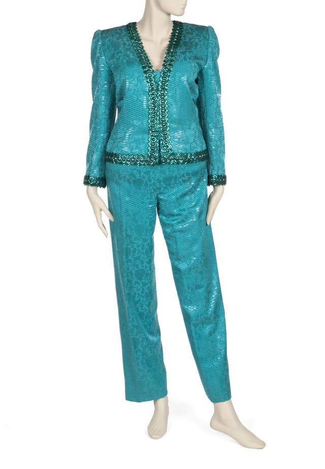 An emerald green silk trouser-suit, green tube beaded mix along v-neck line, jacquard with lame thread weave, matching belt designed by Givenchy and worn by Elizabeth Taylor to a 1987 Aids Fundraiser. Pre-sale estimate: $800