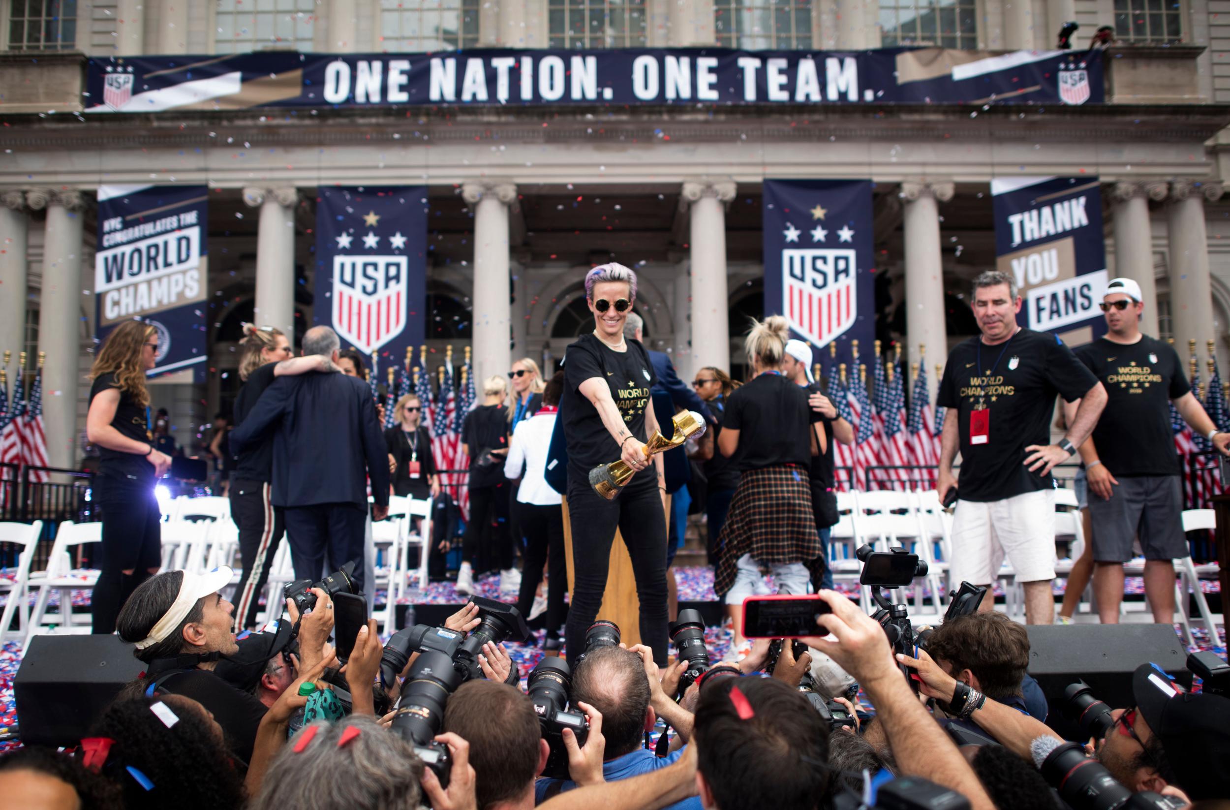 USA women's soccer player Megan Rapinoe holds the trophy in front of the City Hall, 10 July 2019