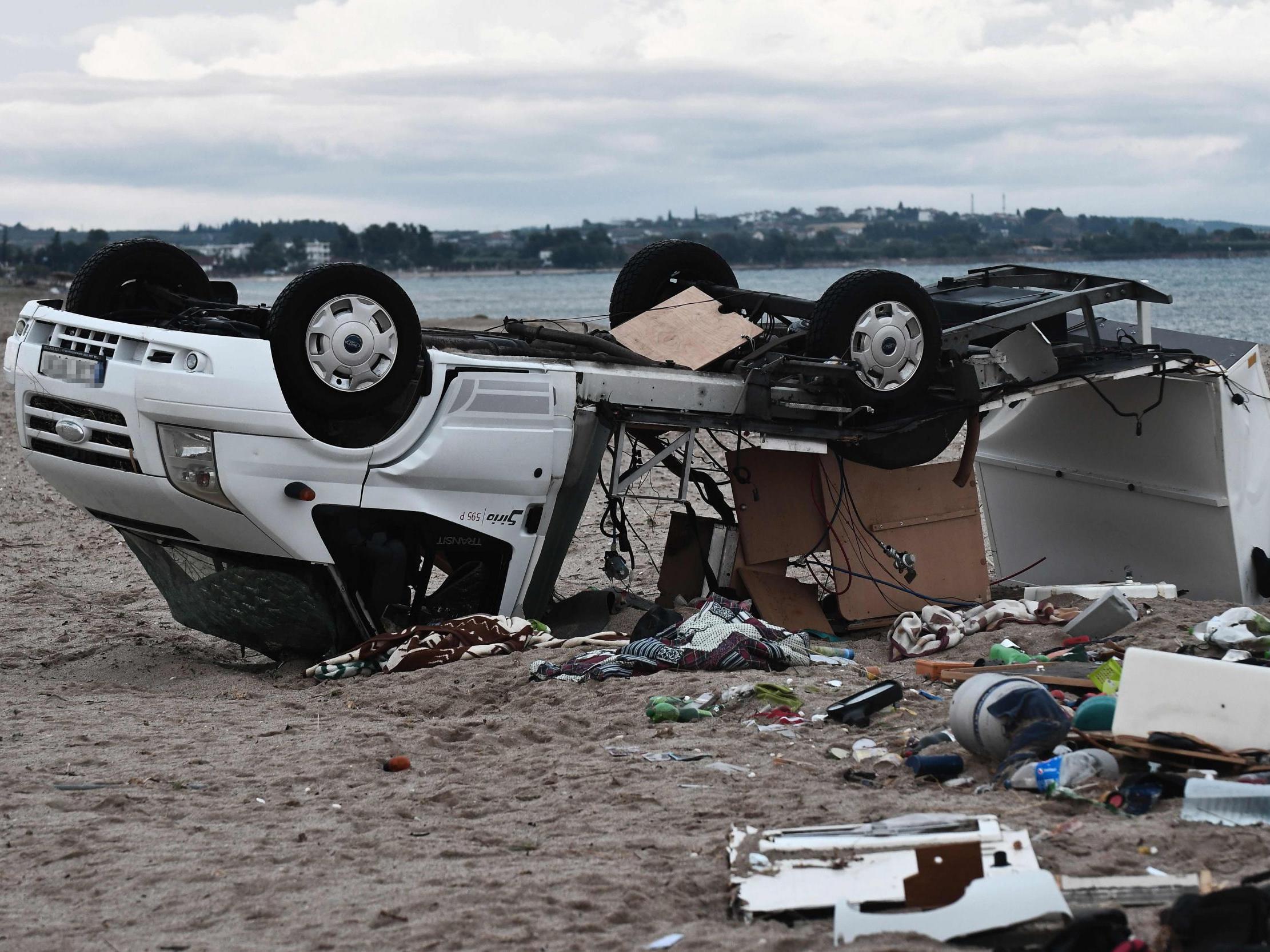 A caravan overturned by strong winds lies on a beach where a storm killed a Czech couple in Nea Plagia, Chalkidiki, northern Greece, on 11 July, 2019.