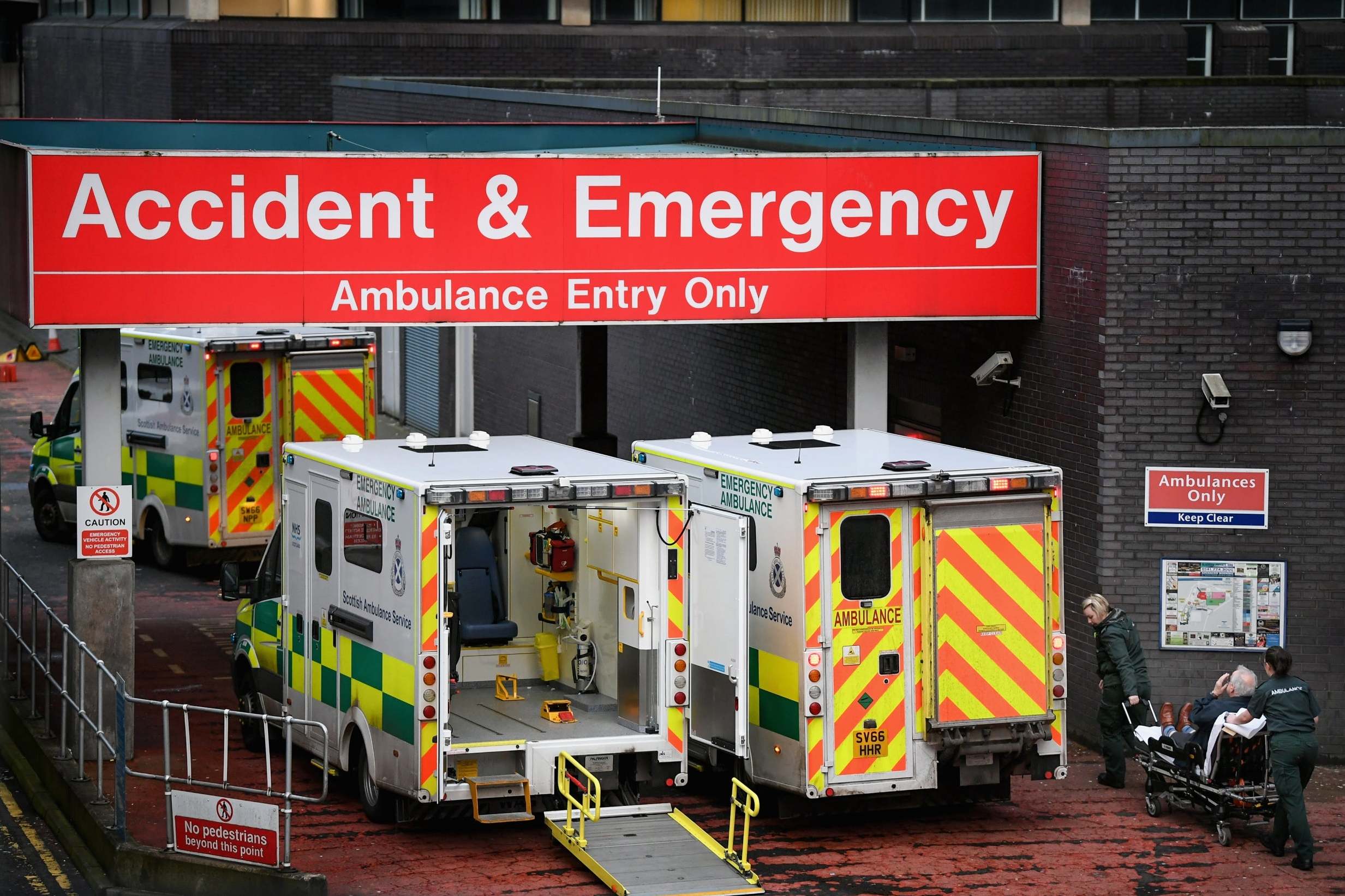 Emergency services are under ‘acute pressure’ amid a surge in Covid-19 cases (picture shows ambulances at Glasgow Royal Hospital)