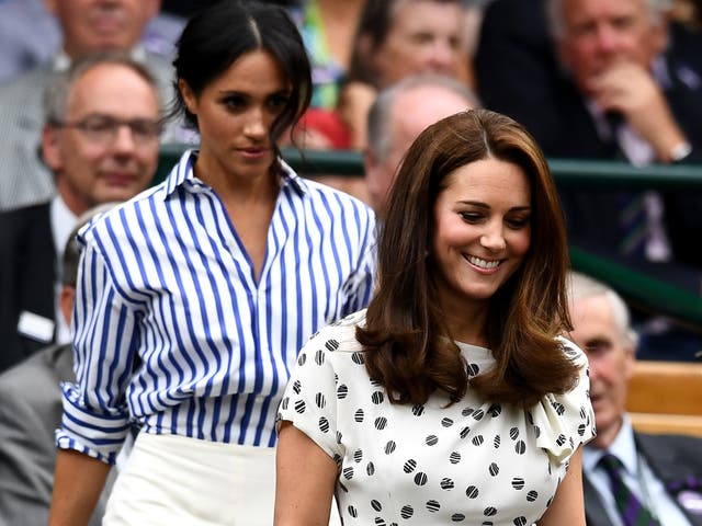 Catherine, Duchess of Cambridge (R) and Meghan, Duchess of Sussex attend day twelve of the Wimbledon Lawn Tennis Championships at All England Lawn Tennis and Croquet Club on July 14, 2018 in London, England.