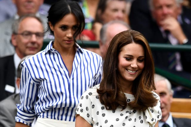 Catherine, Duchess of Cambridge (R) and Meghan, Duchess of Sussex attend day twelve of the Wimbledon Lawn Tennis Championships at All England Lawn Tennis and Croquet Club on July 14, 2018 in London, England.