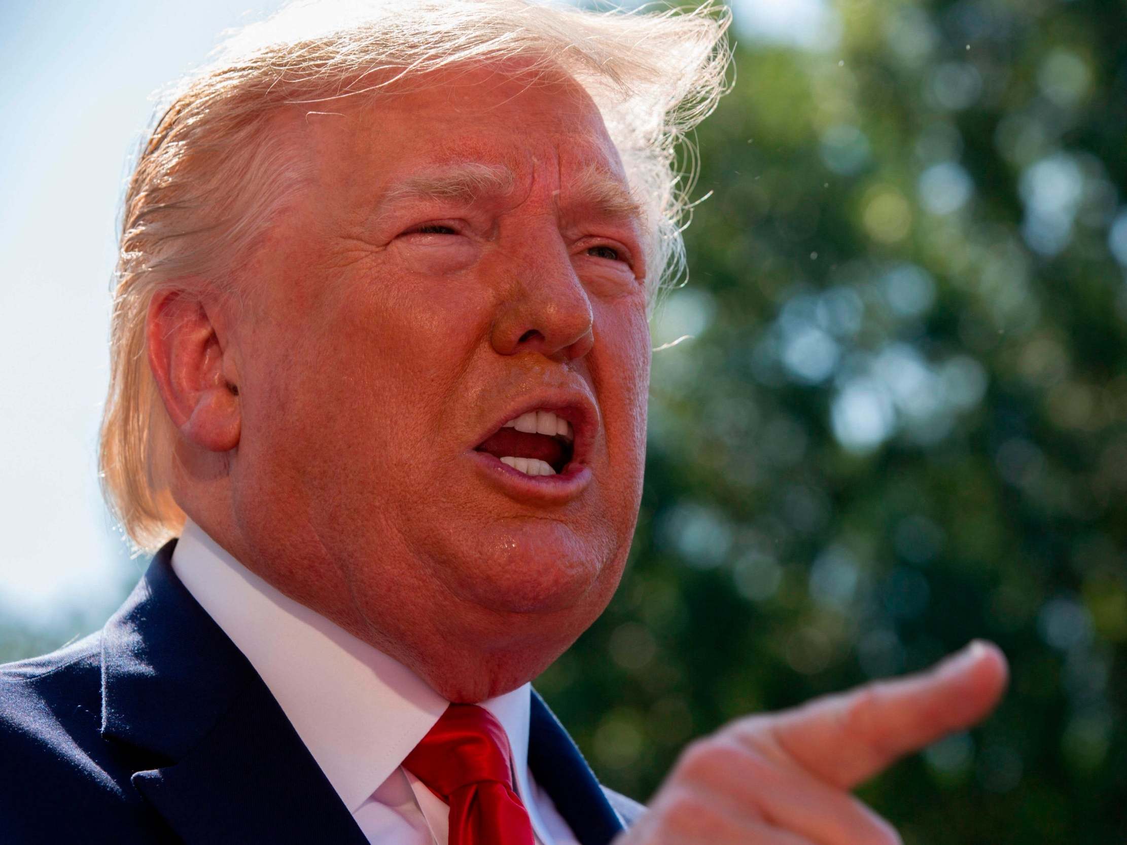 Donald Trump speaks to reporters at the White House on Friday