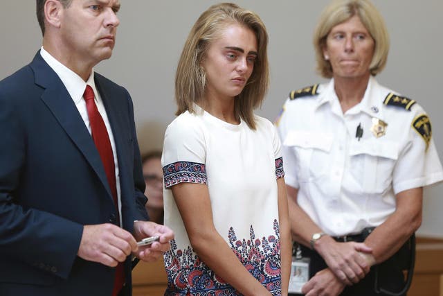 Michelle Carter, center, listens to her sentencing for involuntary manslaughter for encouraging 18-year-old Conrad Roy III to kill himself in July of 2014.