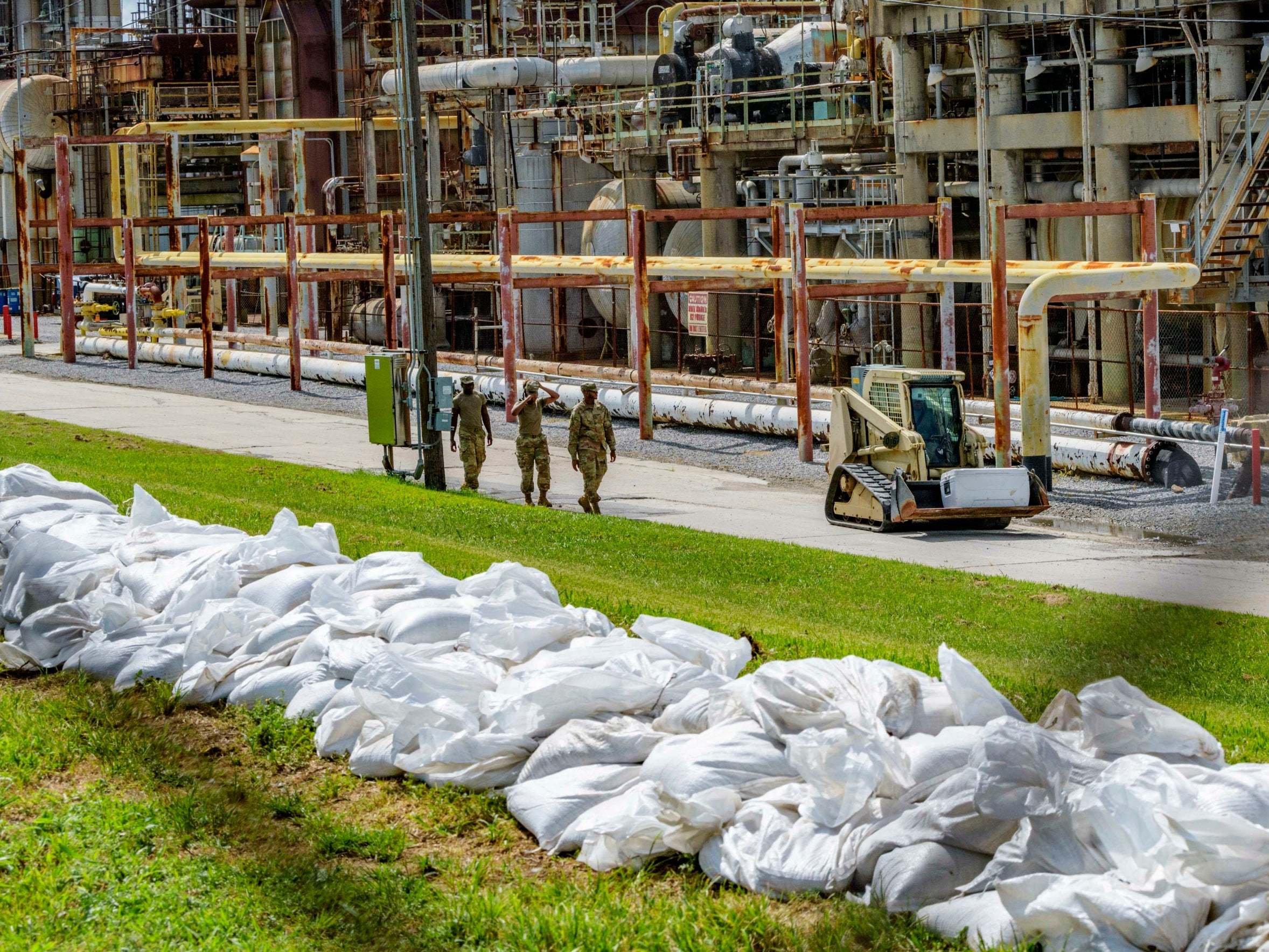 US soldiers add sandbags to levees by a refining plant in Chalmette, Louisiana, before Tropical Storm Barry hits