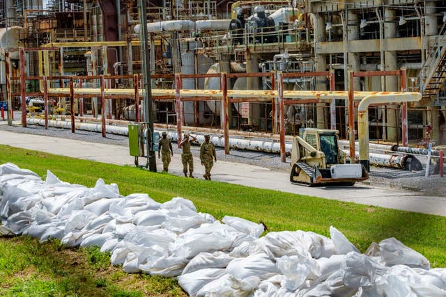 US soldiers add sandbags to levees by a refining plant in Chalmette, Louisiana, before Tropical Storm Barry hits