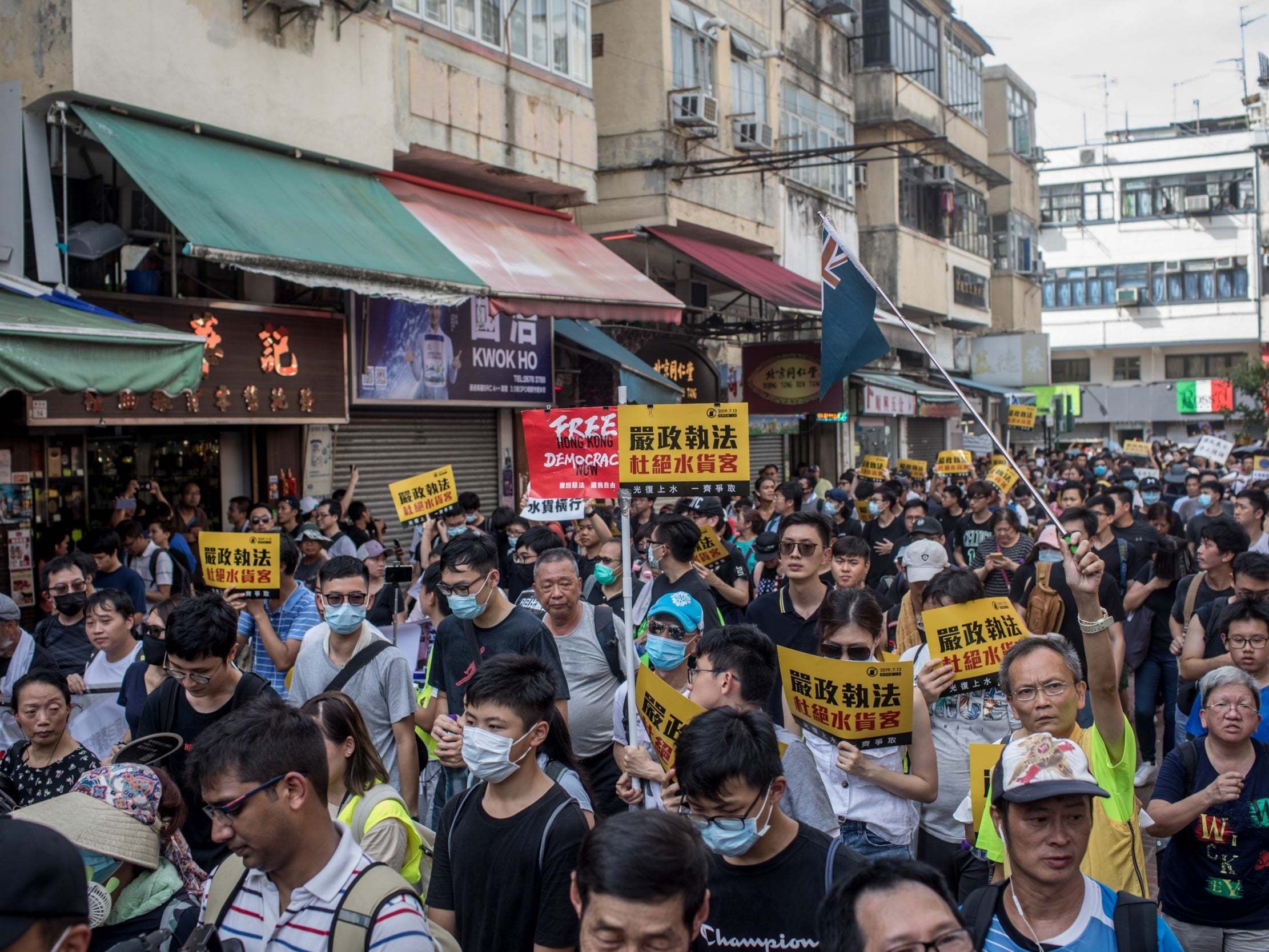 Hong Kong protesters clash with police during anti-Chinese trader march in border town