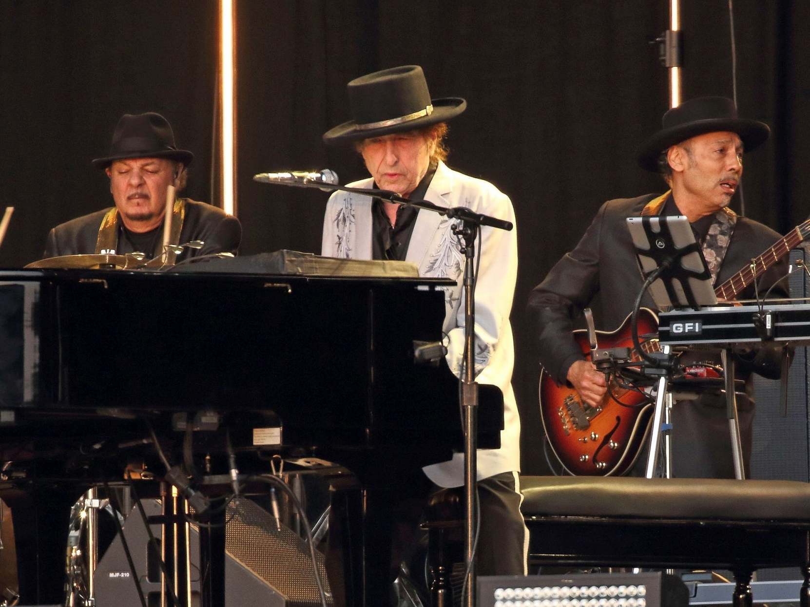 The grizzled man at the piano in a wide-brimmed hat looks like Dylan... (Rex)