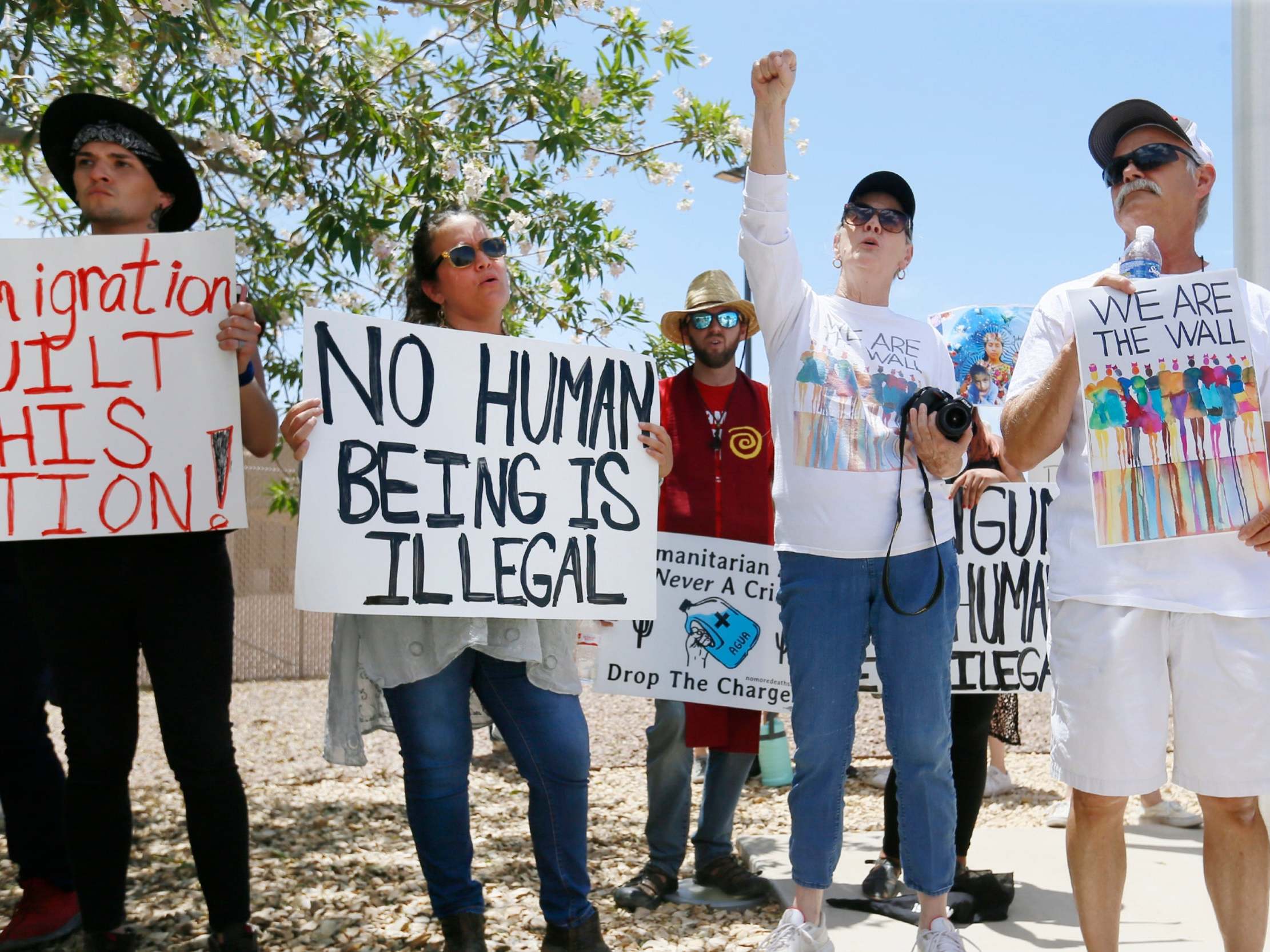 Protesters gather at the front of the Clint Border Patrol station to hear US and Texas lawmakers talk