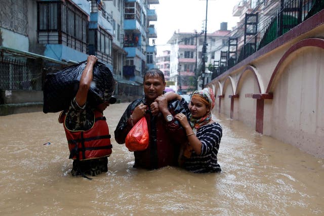 Homes in Nepal have been submerged in flood waters after monsoon rains pounded the country