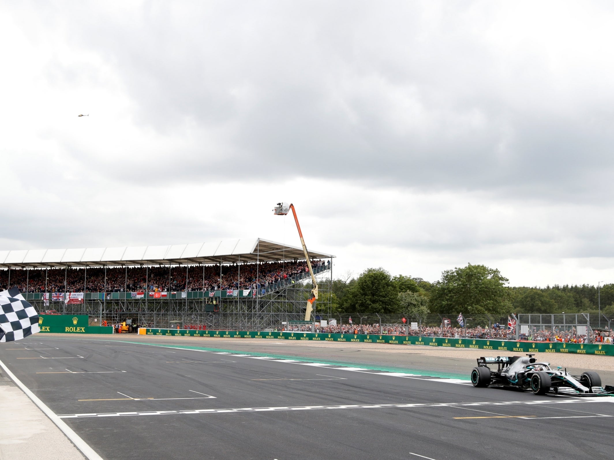 Hamilton crosses the line to win the British Grand Prix for a record sixth time