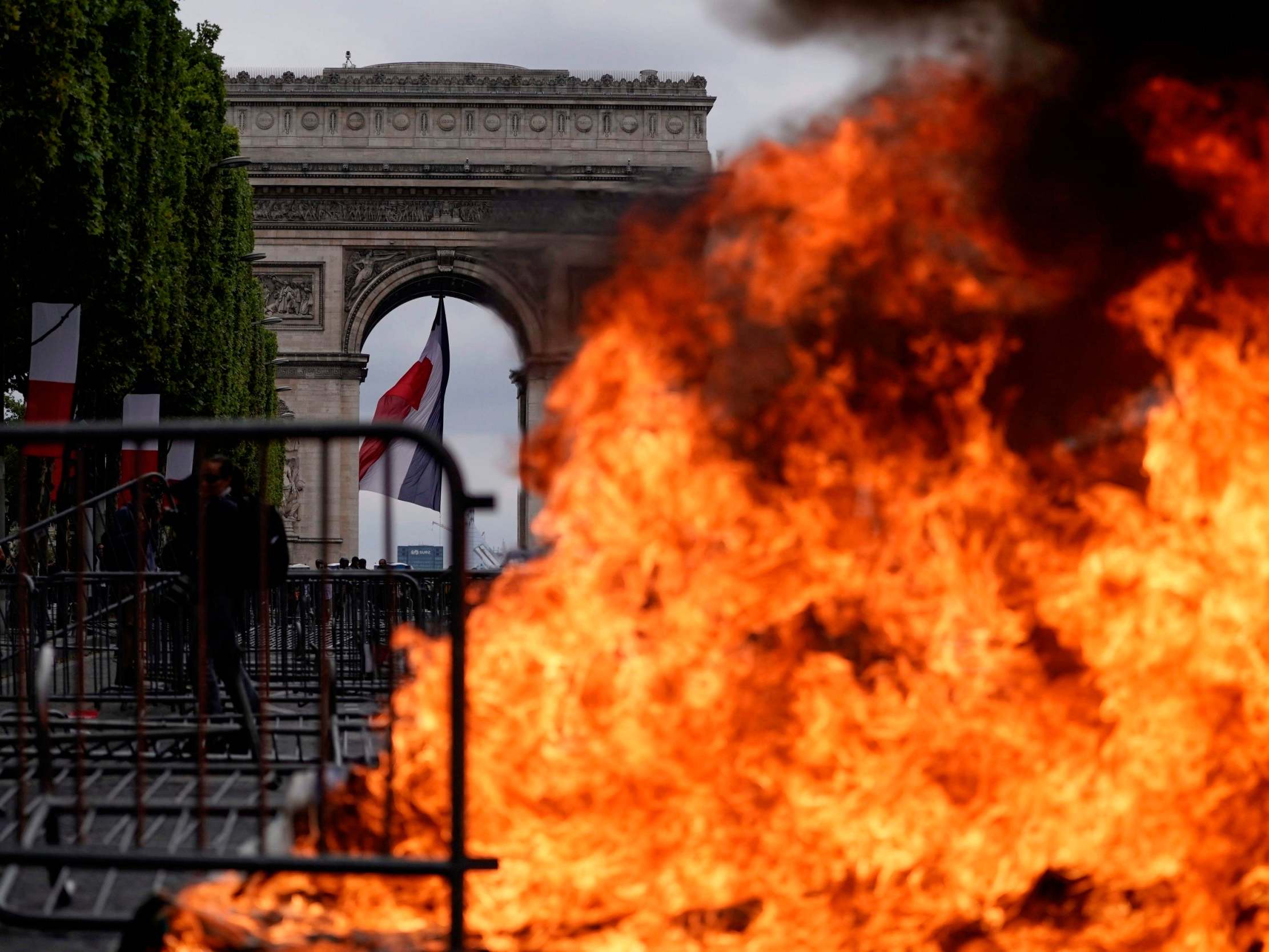 This picture taken on 14 July 2019 shows a fire in front of the Arc de Triomphe in Paris