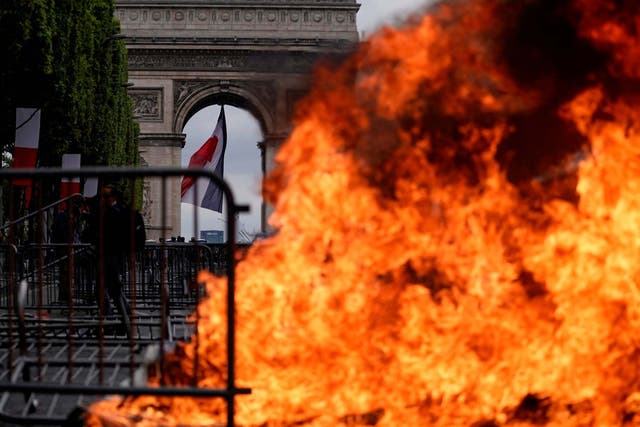 This picture taken on 14 July 2019 shows a fire in front of the Arc de Triomphe in Paris